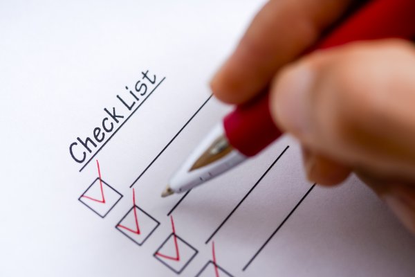 background check services truthfinder money price cost hand with pen in red checking check list boxes